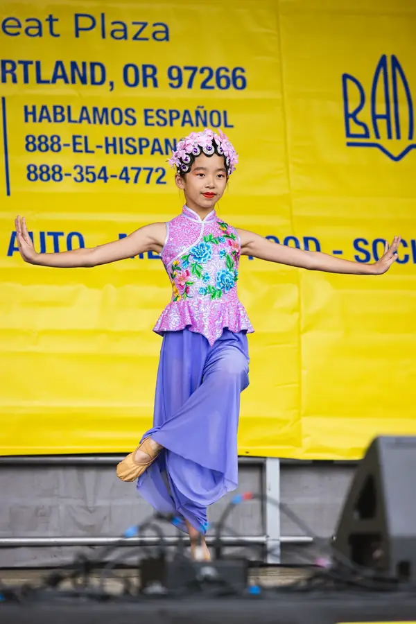 Young Asian dancer performing at a family festival in Portland