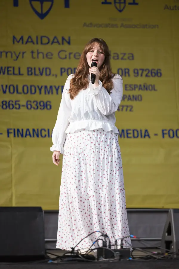 Young singer performing on stage at the Portland Multicultural Kids Festival