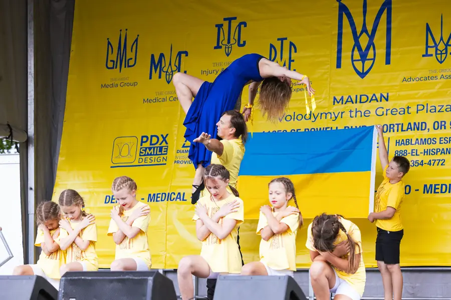 Ukrainian youth dance performance with a flag at Ventura Park in Portland