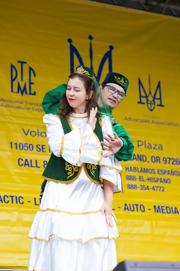 Cultural dancers in green and white costumes at Ventura Park